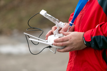 man controlling drone from the transmitter outdoors