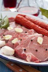 pork with black pepper, smoked sausages and garlic on dish