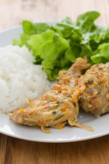 rabbit with sauce,  boiled rice and salad on plate