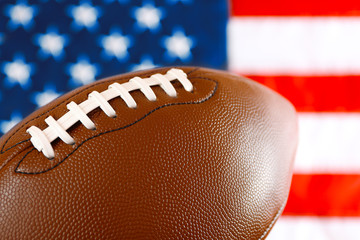 Rugby ball on background of American flag. Popular sport concept
