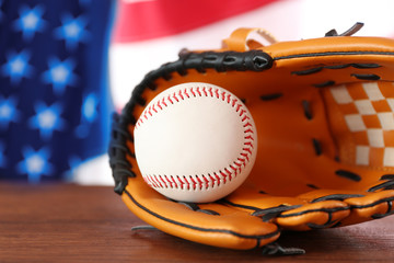 Baseball and glove on background of American flag. Popular sport concept