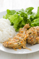 rabbit with sauce,  boiled rice and lettuce on plate