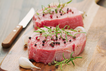 raw meat with pepper and garlic on wooden board