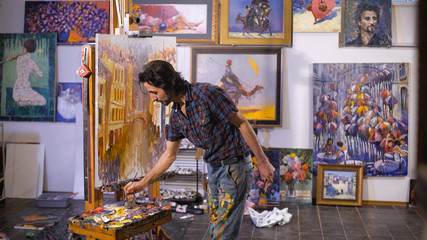 Obraz premium Inspiration. Colorful professional artist paints with oil. Workshop