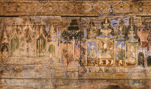Ancient Thai mural painting on wooden temple wall