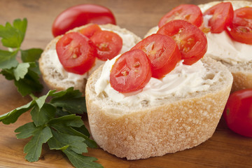 bread slices with cream and tomatoes