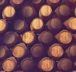 Row of wooden barrels of tawny portwine ( port wine ) in cellar, Porto, Portugal. Vintage old style © sergeialyoshin