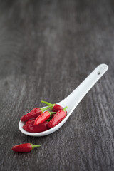 fresh red chilli on old wood background. hot chilli, small capsicum