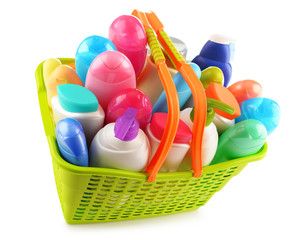 Shopping basket with body care and beauty products over white