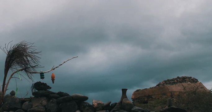 Rolling clouds with interspersed lightning over a rustic seaside ruin