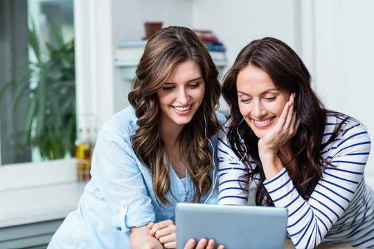 Smiling Friends Watching Video On Digital Tablet