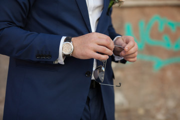 happy stylish elegant groom the background of old city