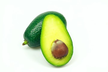 Avocado fruit and one half with seed, on white background.