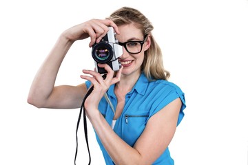 Portrait of smiling woman holding digital camera