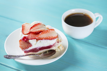eating cake with strawberries and cream on a plate with coffee
