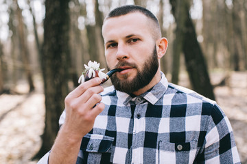 Bearded man with a pipe flowers