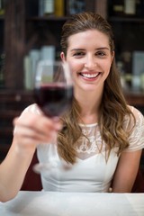 Portrait of smiling woman holding wine glass