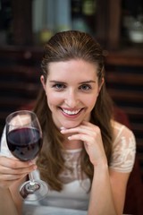 High angle portrait of happy woman holding wine glass