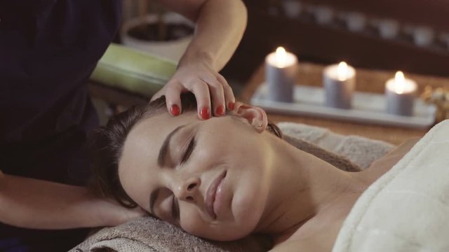 Closeup of woman getting neck and head thai massage