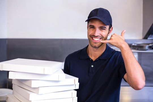 Pizza delivery man carrying boxes - Powered by Adobe