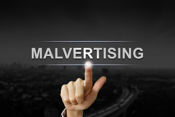 business hand pushing malvertising button 