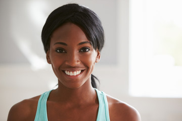 Fototapeta na wymiar Head and shoulders portrait of smiling young black woman