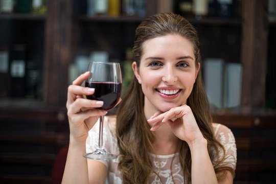Portrait of happy woman holding wine glass