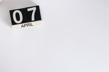 April 7th. Image of april 7 wooden countdown calendar on white background.  Spring day, empty space for text. Save the data