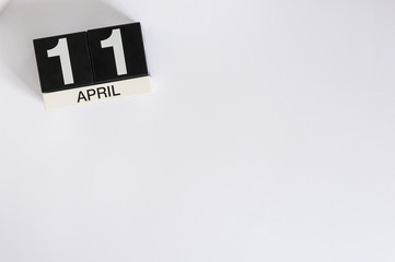 April 11th. Image of april 11 wooden countdown calendar on white background.  Spring day, empty...