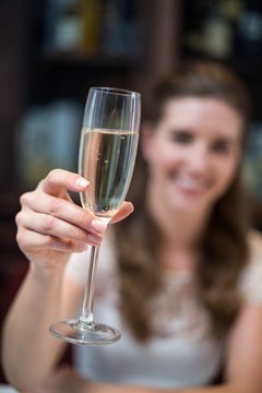 Close-up of happy woman holding champagne flute