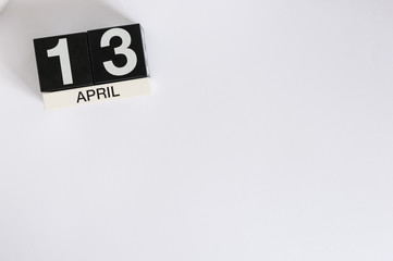 April 13th. Image of april 13 wooden countdown calendar on white background.  Spring day, empty space for text. World Rock-n-roll Day