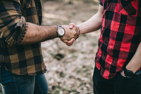 Bearded men shake hands