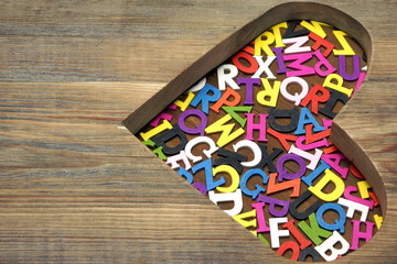 Many Colored Letters In The Wooden Heart Shape
