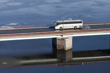 the tourist bus going on  bridge through  river