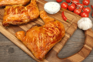 Two Grilled BBQ Chicken Leg Quarter On Wood Board