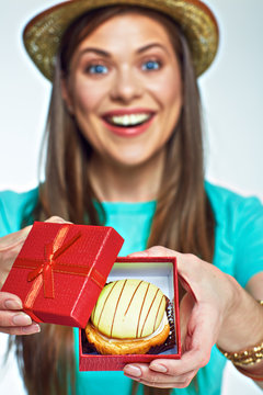 Woman received present gift box with cake.