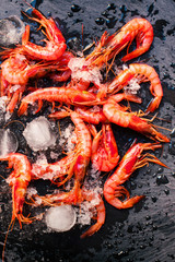 fresh raw shrimps on a black board.