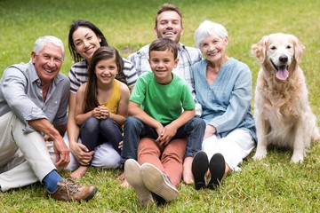Portrait of cheerful extended family sitting in the park