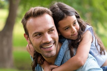 Young girl rides piggyback 