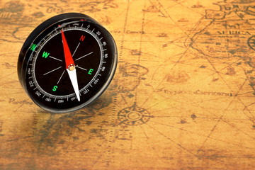 Fototapeta na wymiar Magnetic Compass On The Old Map, Closeup