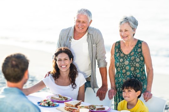 Happy Family Having A Picnic At The Beach