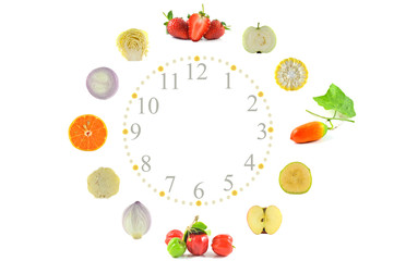 Fruit and vegetable clock on white background