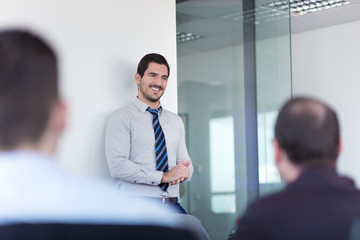 Relaxed cheerful team leader and business owner leading informal in-house business meeting....