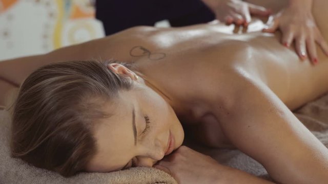 young woman having massage at spa