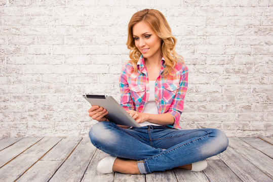 Portrait Of  Woman Sitting On Floor With Crossed Legs And Tablet