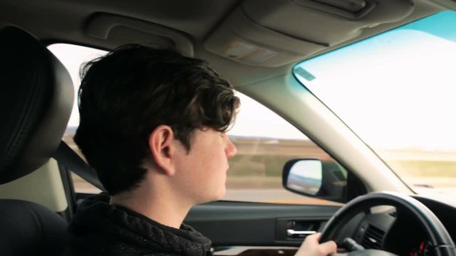 Teenage boy learning to drive on interstate highway