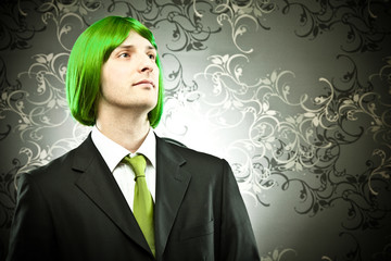 businessman with colored tie and hair wig on tapestry background