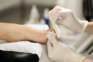 Close-up of sterile pedicure process. Manicurist works accurately and efficiently.