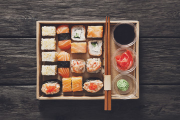 Set of sushi maki and rolls at black rustic wood. © Prostock-studio