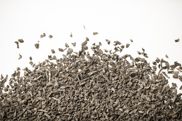 Dry black tea leaves as texture for background. Toned